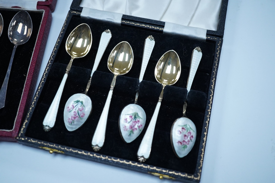 A cased set of six silver gilt and enamel coffee spoons, Adie Brothers, Birmingham, 1966, together with two other cased sets of coffee spoons including a mother of pearl set and a silver set.